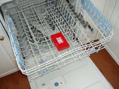 Put the wax brush in the top rack of your dishwasher