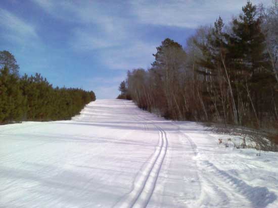 The final downhill to the lake at Wheeler Rd, holding up to the sun on Thursday, Feb 16, 2:30 PM