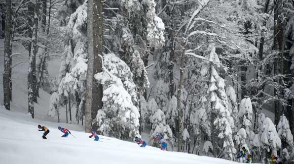 Skiers race through a scenic landscape of snow at the Laura Cross Country Ski Center near Sochi. (Getty Images/AFP)