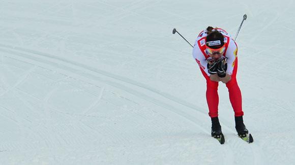 Justyna Kowalczyk tucks down the hill to take the win in a 3k classic individual start race in stage five of the Tour de Ski in Toblach, Italy. (Getty Images/AFP)