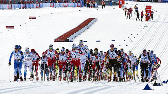 Women head out at the start of the skiathlon skiing 7.5k classic before switching skis to freestyle. (Getty Images/AFP-Jonathan Nackstrand)