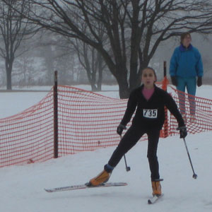 Rylee Raye Robinson crossing the finish line at the Frosty Freestyle xc ski race