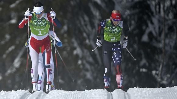 Kikkan Randall, seen here with Norway’s Marit Bjoergen at the 2014 Sochi Olympic Winter Games, skied to a career-best 12th in the 30k classic World Cup at Holmenkollen Sunday. (Getty Images/AFP/Pierre-Philippe Marcou)