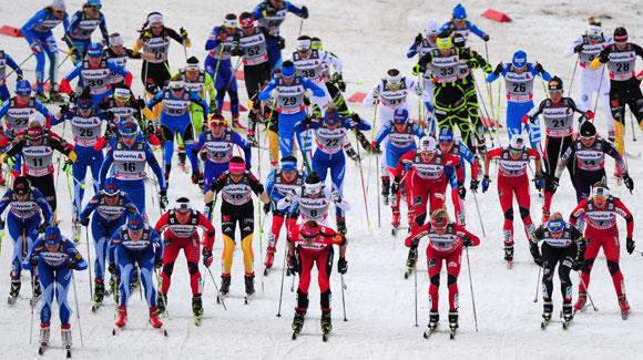 A huge pack heads onto the trail for the New Year's Day skiathlon. Look for Kikkan Randall in the black Bjoern Daehlie U.S. Ski Team uniform on the far right. (Getty Images/AFP-Johannes Eisele)