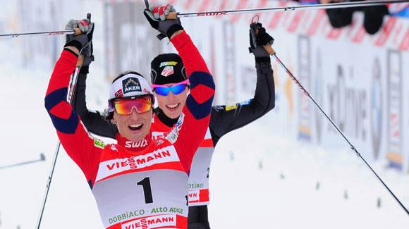 	 Two champions of the sport cross the finish line in celebration as Norway's Marit Bjoergen takes a strategic win followed closely by Kikkan Randall, who moved up to fourth in the Tour de Ski. (Getty Images/AFP)