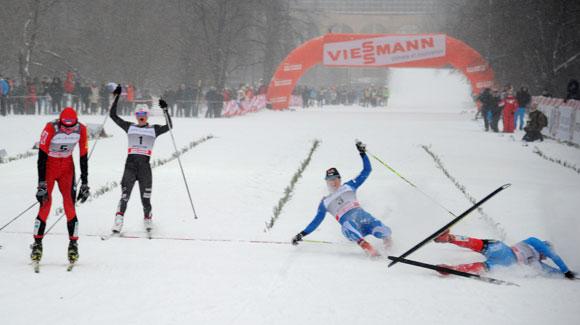 American Jessie Diggins (bib 1) comes across the line behind winner Justyna Kowalczyk as other skiers collapse in exhaustion in the Moscow sprint. (Getty Images/AFP-Alexander Nemenov)