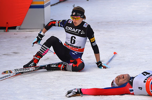Liz Stephen collapses in the finish after skiing to an historic fifth in the final standings of the Tour de Ski, fourth fastest up the Alpe Cermis. (Getty Images/AFP - Vincento Pinto)