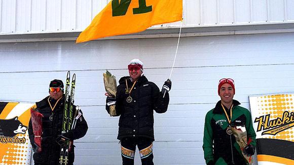 Kyle Bratrud proudly waves his NMU flag after winning the 15k freestyle at the U.S. Cross Country Championships. (Andrew Gardner)