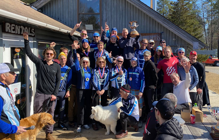 Cross country ski headquarters ski racers holding the 2024 Michigan Cup