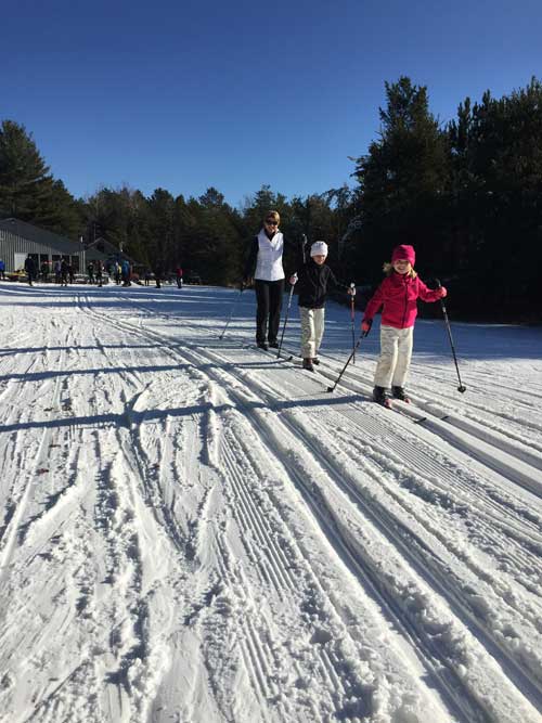 Mom and kids cross country skiing at Cross Country Ski Headquarters