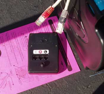 Sixth step for building the Vasa Ergometer: Unpack the monitor. Plug the red and black cables from the front assembly into the color-coded connecton ports on the monitor.