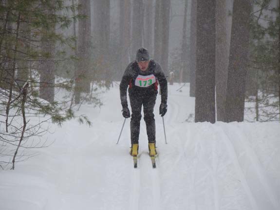 Lee Gearic races through the pines on his fourth lap