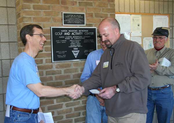 Mike Muha presents $2,590 to Jerry Cyr from the Frosty Freestyle XC ski race