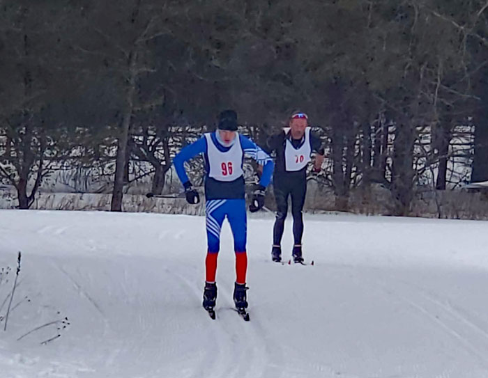 Elijah Klee and Bob Smith race around the finishing corner to the finish
