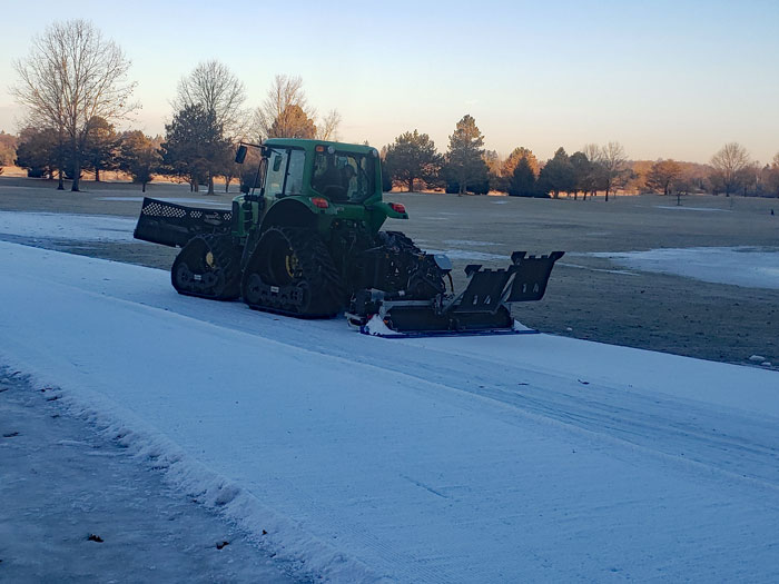 The Mueller snow groomer and track setter drives off into the distance